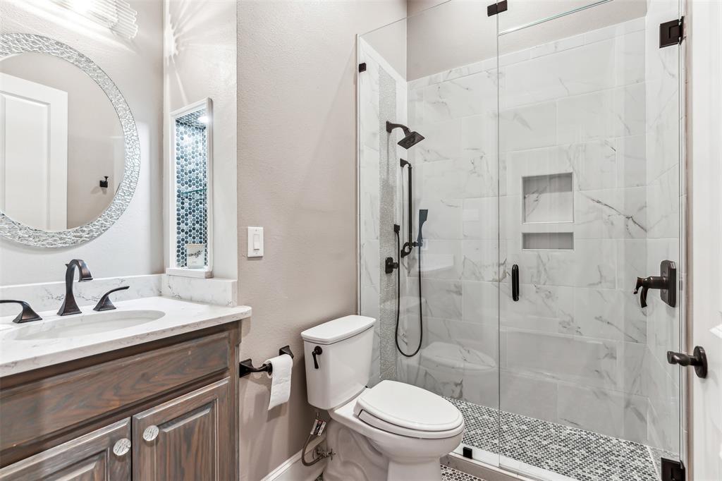 1815 West Forest Grove Road Lucas, TX 75002 - Photo 25 of 40 Bathroom with vanity, toilet, and a marble finish shower