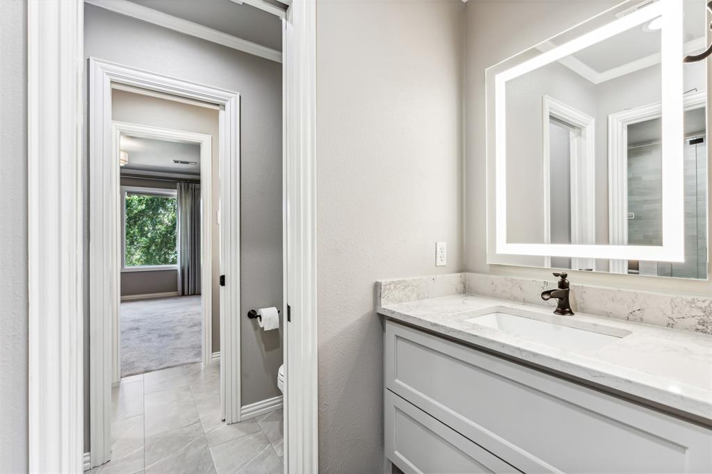 1815 West Forest Grove Road Lucas, TX 75002 - Photo 29 of 40 Bathroom featuring toilet, vanity, crown molding, and baseboards