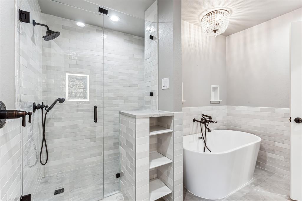 1815 West Forest Grove Road Lucas, TX 75002 - Photo 30 of 40 Bathroom with a shower stall, a freestanding tub, tile walls, and a wainscoted wall