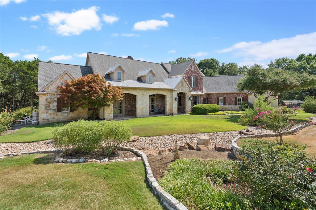 1815 West Forest Grove Road Lucas, TX 75002 - Photo 3 of 40 View of front facade with stone siding, a chimney, and a front lawn