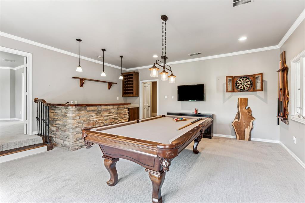 1815 West Forest Grove Road Lucas, TX 75002 - Photo 32 of 40 Game room featuring visible vents, wet bar, light colored carpet, and crown molding