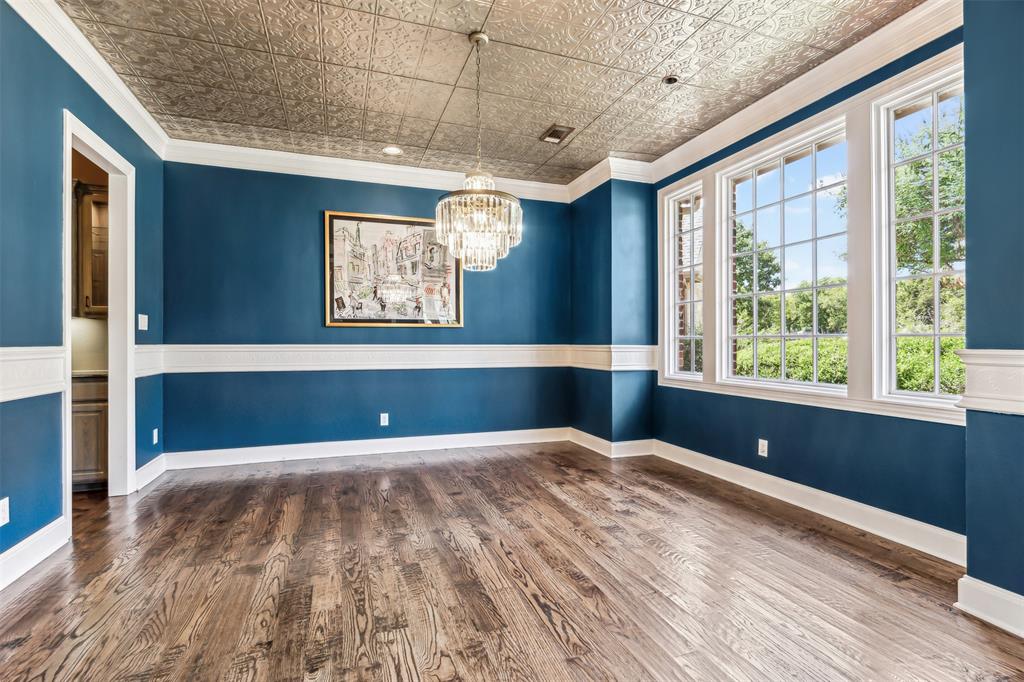 1815 West Forest Grove Road Lucas, TX 75002 - Photo 7 of 40 Spare room featuring wood finished floors, baseboards, and an ornate ceiling