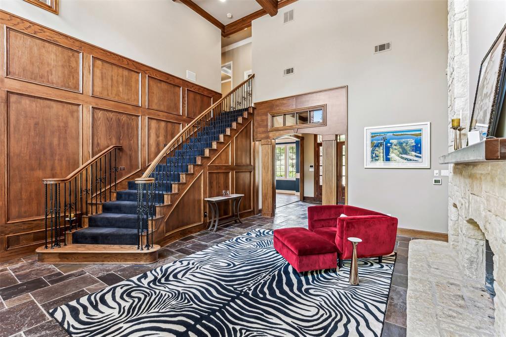 1815 West Forest Grove Road Lucas, TX 75002 - Photo 8 of 40 Living area with stone tile flooring, visible vents, arched walkways, and stairway