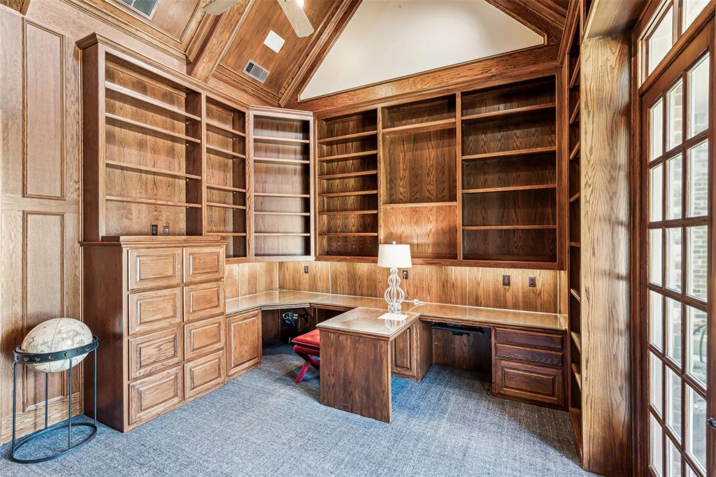 1815 West Forest Grove Road Lucas, TX 75002 - Photo 10 of 40 Unfurnished office with wood walls, dark carpet, lofted ceiling with beams, built in study area, and a ceiling fan