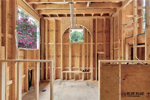 a view of a house with wooden walls and a yard