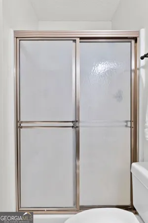a bathroom with a glass shower door