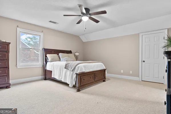 a bedroom with a bed and a large window