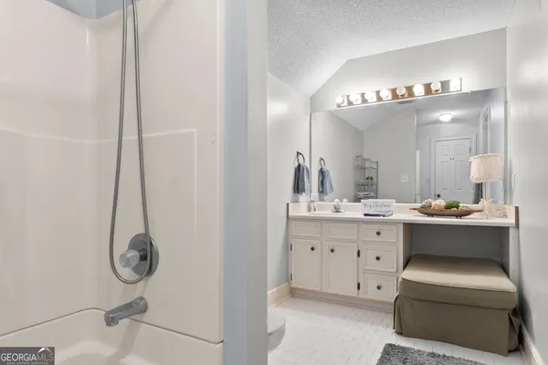 a room with a mirror and furniture