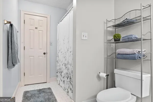 a bathroom with a toilet and shower