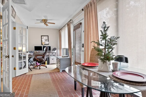 a view of a dining room with furniture a rug and wooden floor