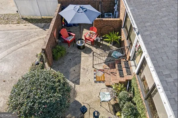 an aerial view of residential house with outdoor space and trees