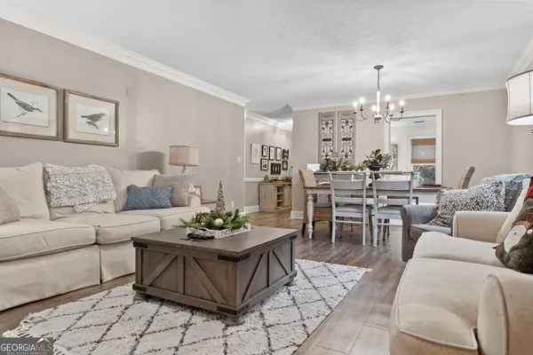 a living room with furniture and a chandelier