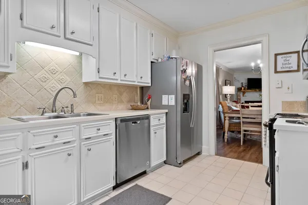 a kitchen with appliances a sink and cabinets
