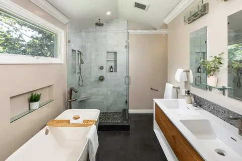 a bathroom with a sink a toilet and shower