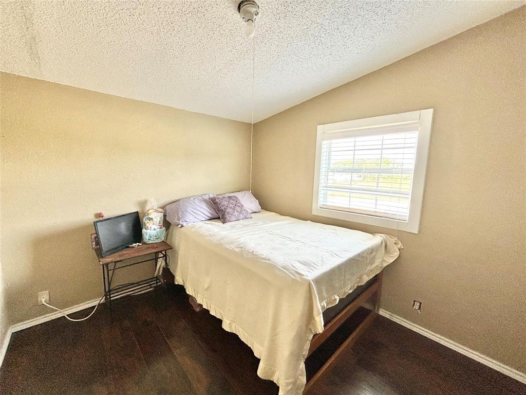 119 Overlook Trail Azle, TX 76020 - Photo 19 of 20 a bedroom with a bed and wooden floor