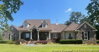 6565 Maxwell Road Stedman, NC 28391 - Photo 1 of 48 a view of a white house with a big yard and potted plants