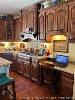 6565 Maxwell Road Stedman, NC 28391 - Photo 6 of 48 a kitchen with stainless steel appliances wooden cabinets and a stove top oven