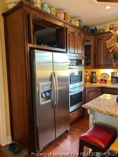 6565 Maxwell Road Stedman, NC 28391 - Photo 10 of 48 a kitchen with stainless steel appliances granite countertop a refrigerator and a microwave