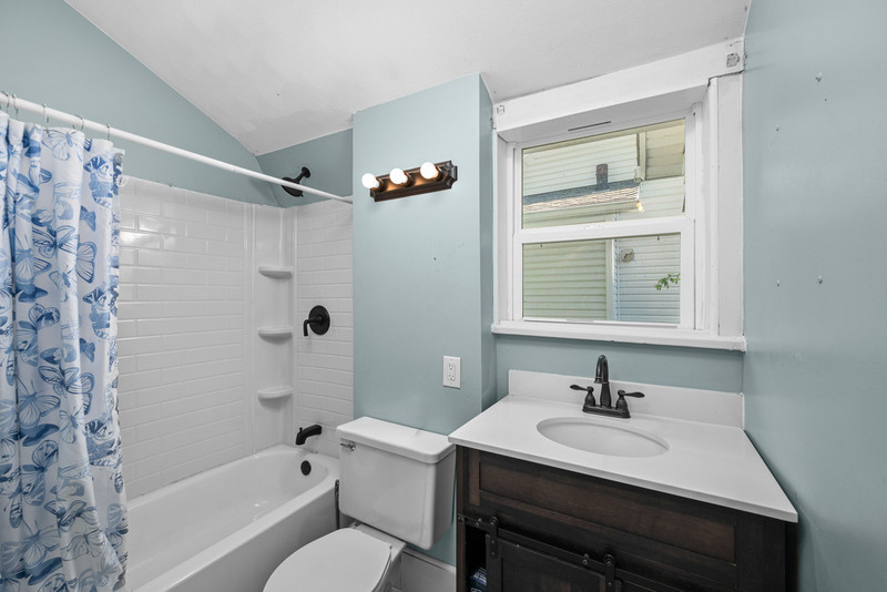 1419 17th Street Moline, IL 61265 - Photo 25 of 28 a bathroom with a sink toilet a mirror and shower