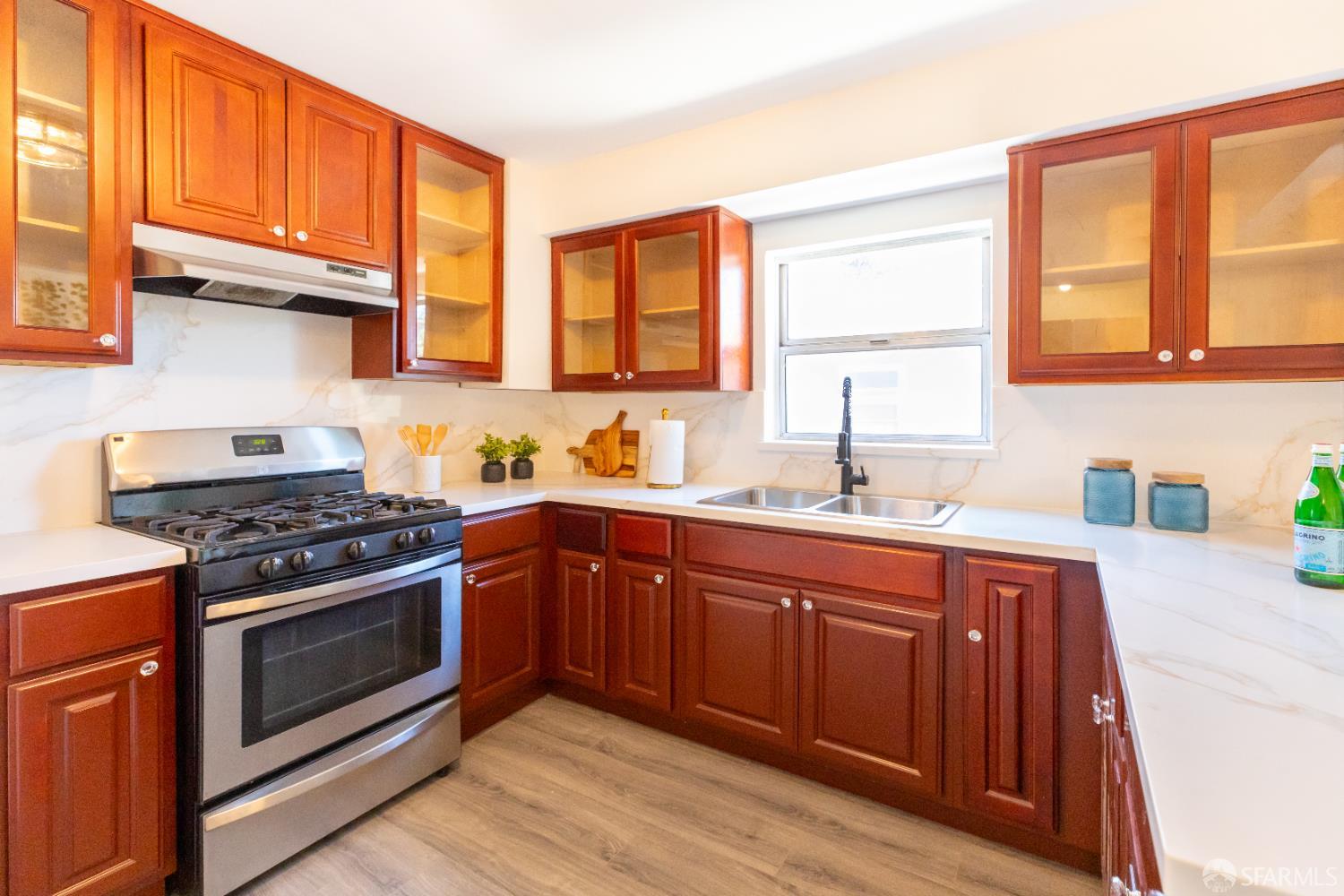 808 Fourth Street Rodeo, CA 94572 - Photo 16 of 70 a kitchen with stainless steel appliances wooden cabinets and a stove top oven