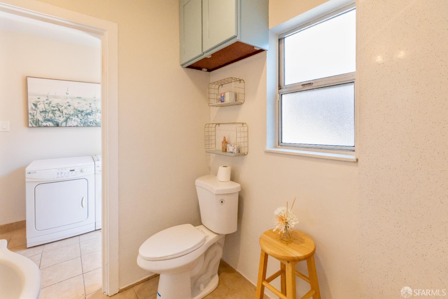 808 Fourth Street Rodeo, CA 94572 - Photo 26 of 70 a white toilet sitting next to a bathroom sink