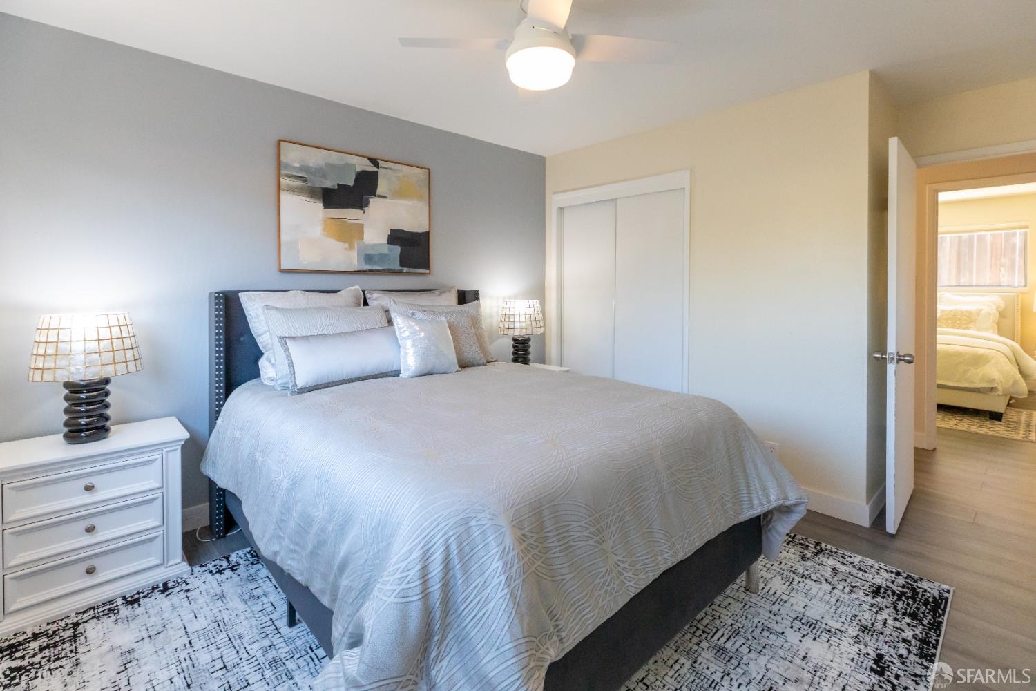 808 Fourth Street Rodeo, CA 94572 - Photo 40 of 70 a bedroom with a bed and a chandelier