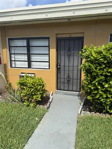 a potted plant in front of a house