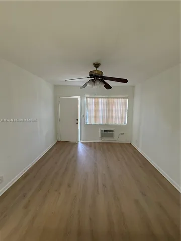 an empty room with a empty space and windows