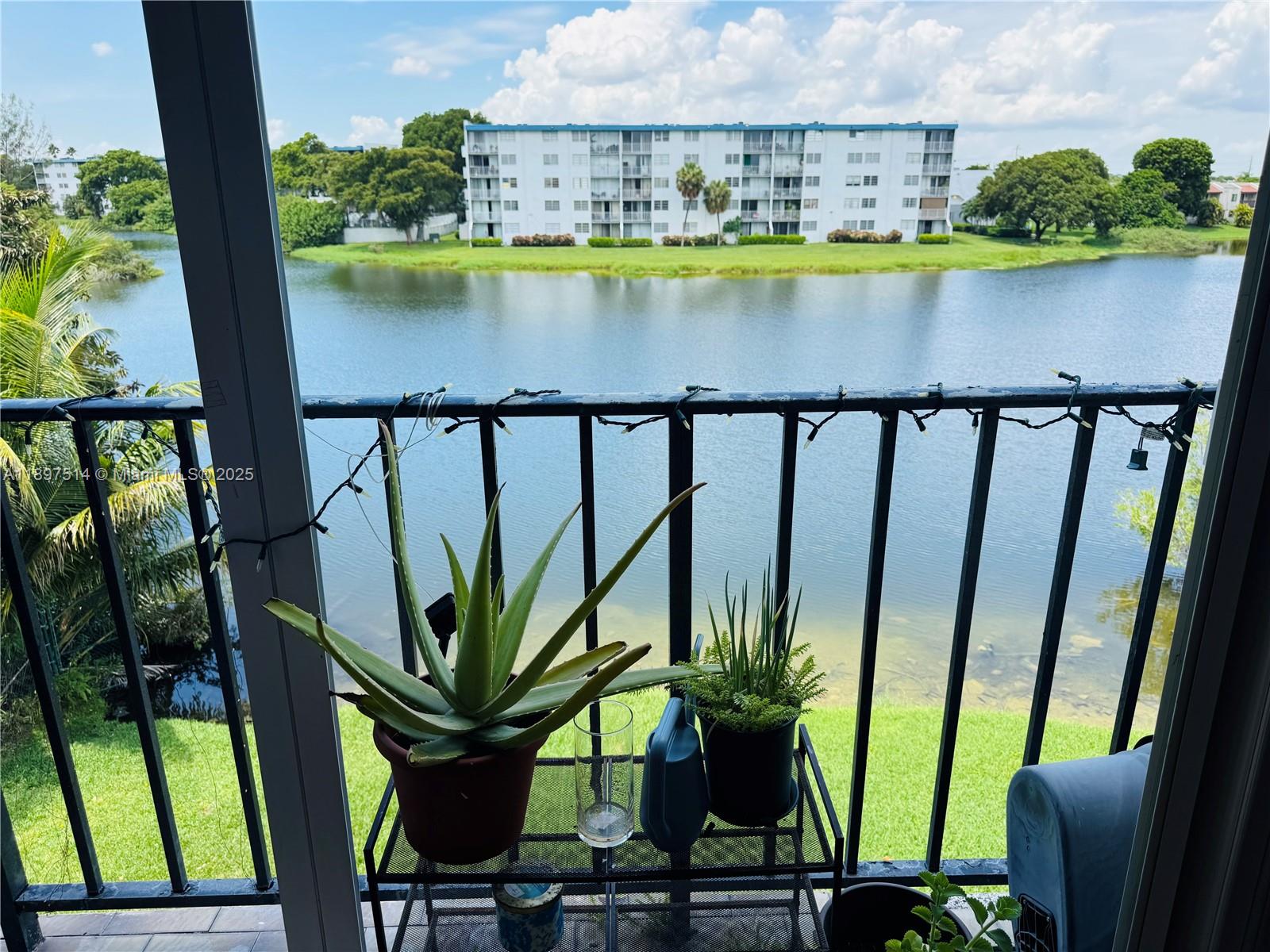502 Northwest 87th Avenue, Unit 302 Miami, FL 33172 - Photo 4 of 12 a view of a lake with a floor to ceiling window next to a yard
