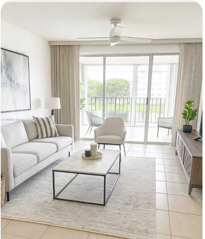 502 Northwest 87th Avenue, Unit 302 Miami, FL 33172 - Photo 5 of 12 a living room with furniture and a large window