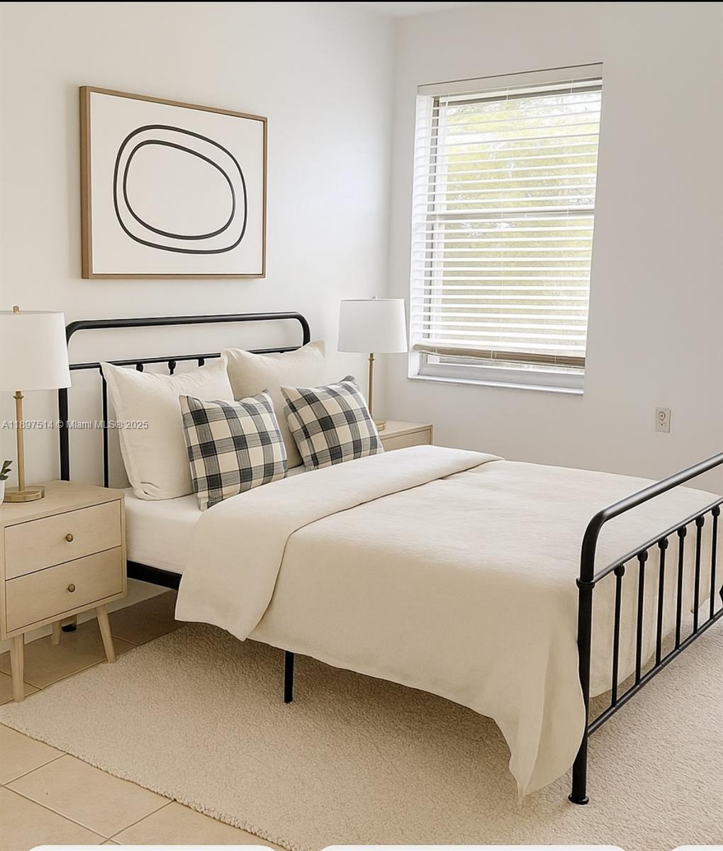 502 Northwest 87th Avenue, Unit 302 Miami, FL 33172 - Photo 6 of 12 a bedroom with a bed and a window