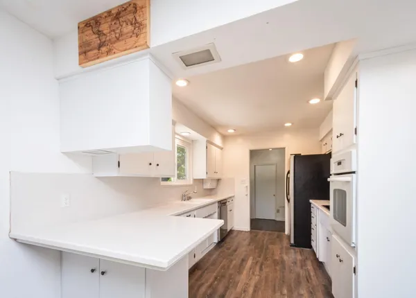 a kitchen with stainless steel appliances a refrigerator sink and wooden cabinets