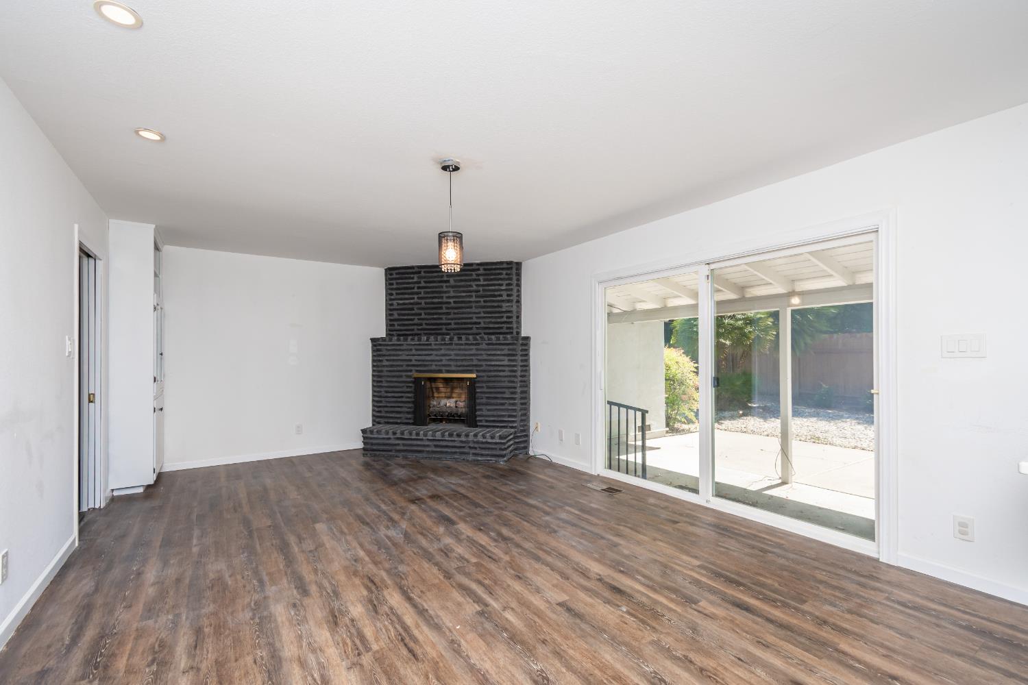 4186 Dena Way Sacramento, CA 95821 - Photo 18 of 48 a view of empty room with wooden floor and fireplace