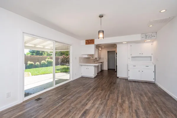a view of a kitchen with a sink and wooden floor