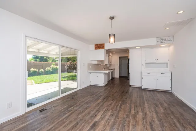 a view of a kitchen with a sink and wooden floor