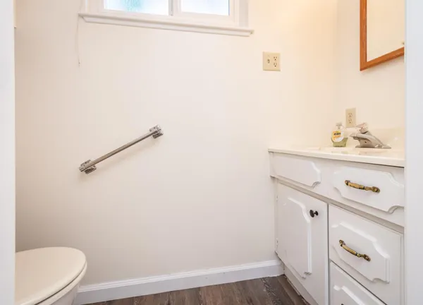 a bathroom with a sink a toilet and vanity
