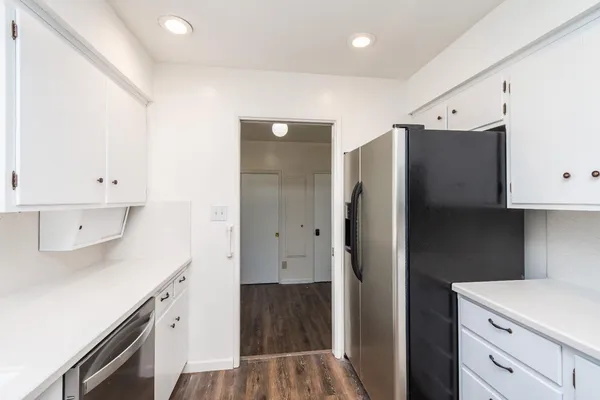 a kitchen with a refrigerator and a stove