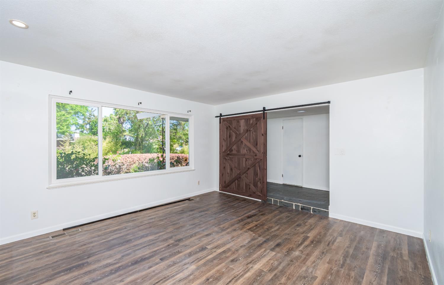 4186 Dena Way Sacramento, CA 95821 - Photo 8 of 48 an empty room with wooden floor and windows