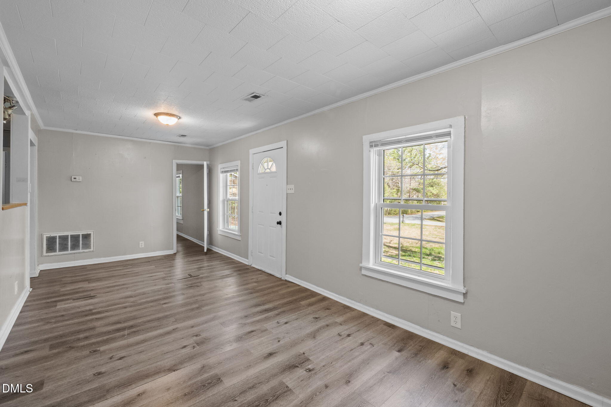 560 Harper Road Hillsborough, NC 27278 - Photo 12 of 44 an empty room with wooden floor and windows