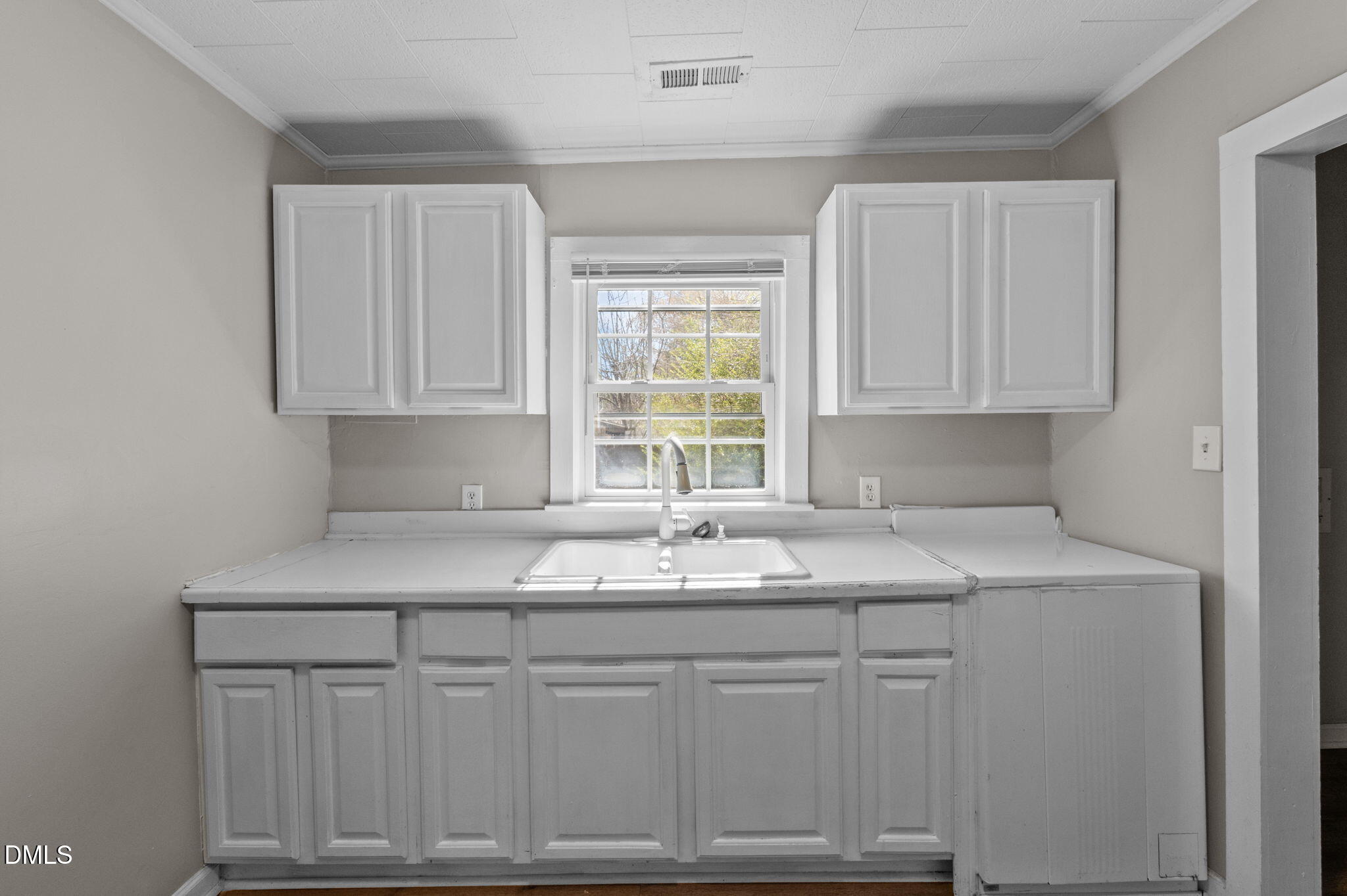 560 Harper Road Hillsborough, NC 27278 - Photo 15 of 44 a kitchen with white cabinets granite counter tops and a window