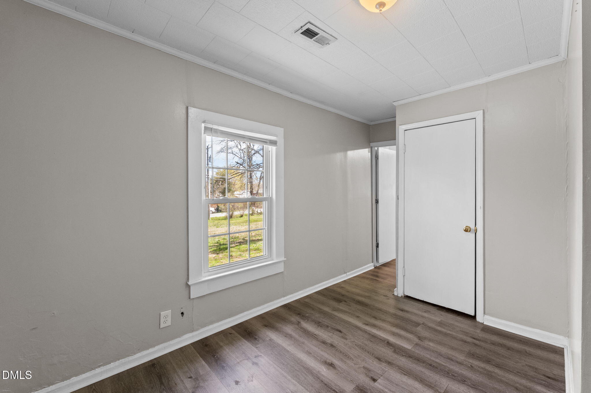 560 Harper Road Hillsborough, NC 27278 - Photo 25 of 44 a view of an empty room with wooden floor and a window
