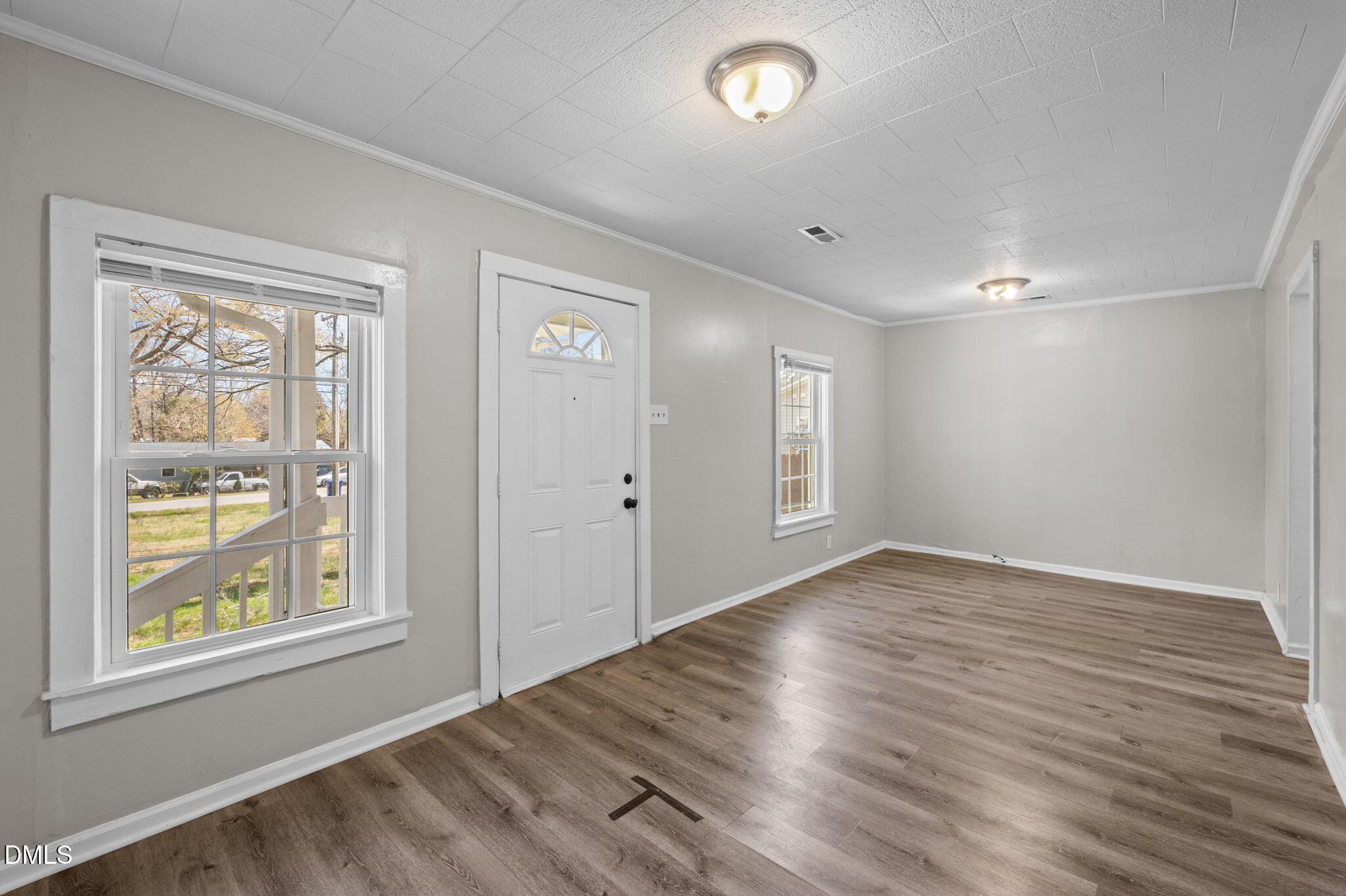 560 Harper Road Hillsborough, NC 27278 - Photo 10 of 44 an empty room with wooden floor and windows