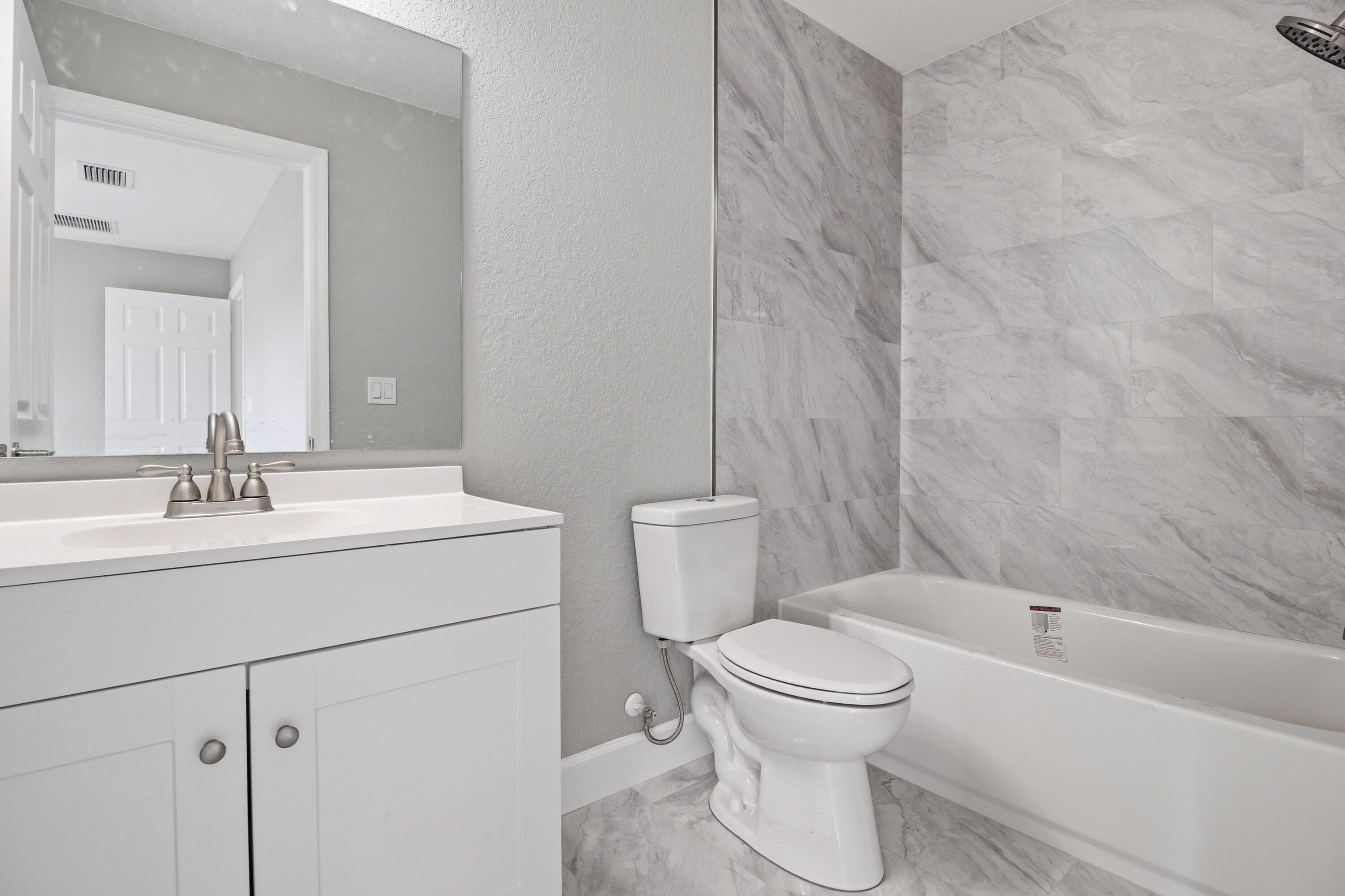 2805 Southeast Carroll Street Stuart, FL 34997 - Photo 17 of 21 a bathroom with a sink toilet and shower