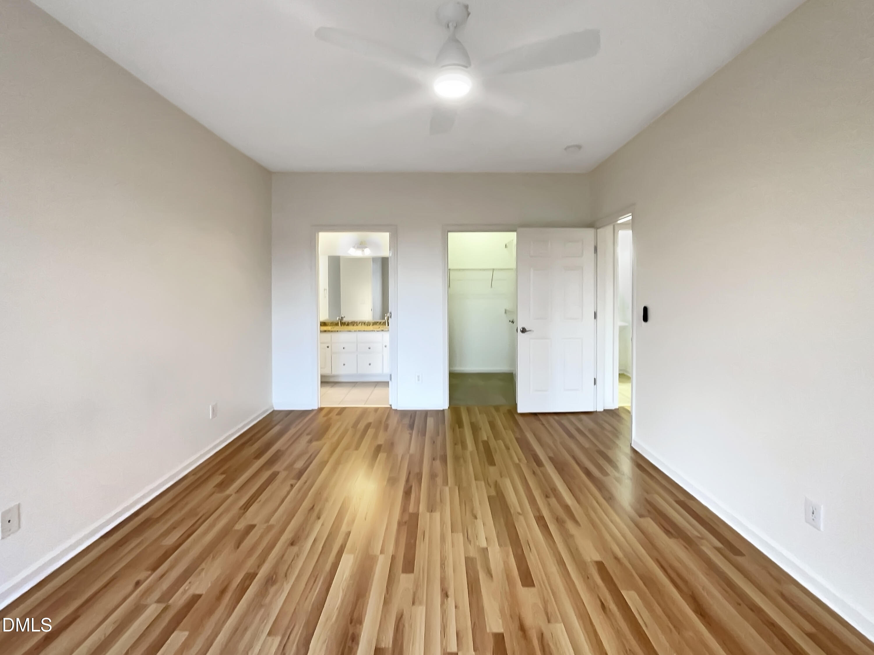 2501 Huntscroft Lane, Unit 203 Raleigh, NC 27617 - Photo 4 of 16 a view of an empty room with wooden floor and a window