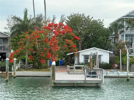 a front view of a house with swimming pool and porch
