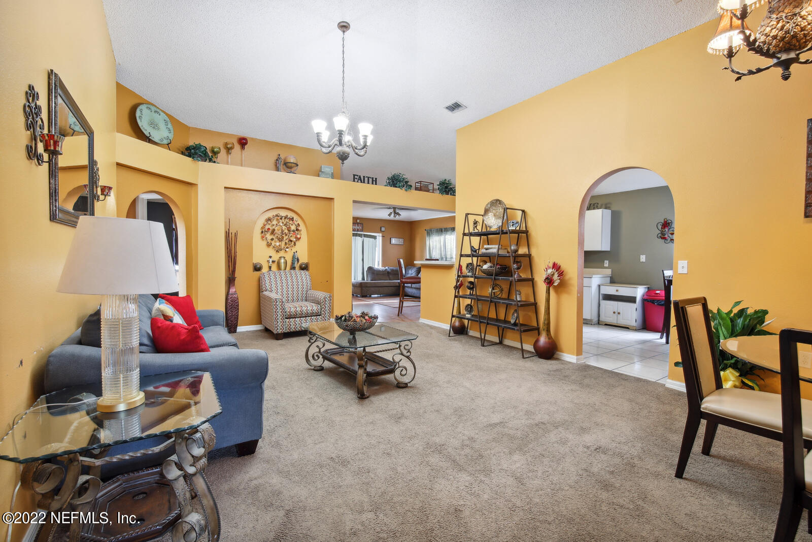 7354 High Bluff Road North Jacksonville, FL 32244 - Photo 5 of 26 a living room with furniture and a chandelier