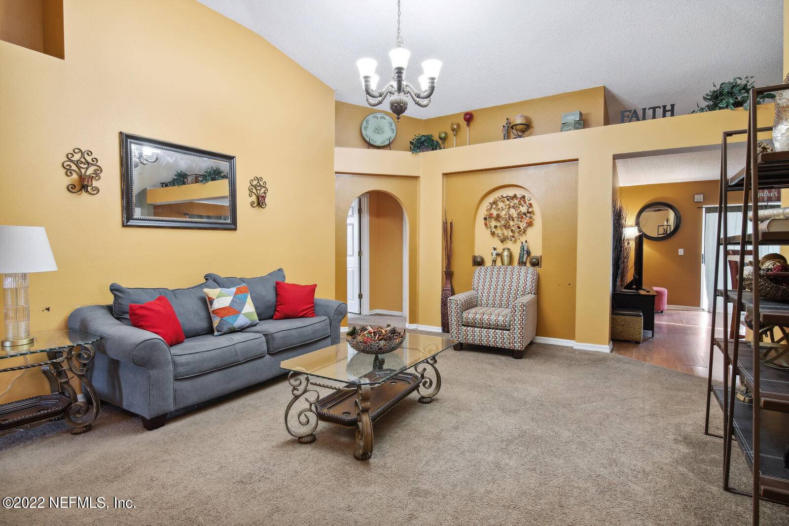 7354 High Bluff Road North Jacksonville, FL 32244 - Photo 6 of 26 a living room with furniture a chandelier and a flat screen tv