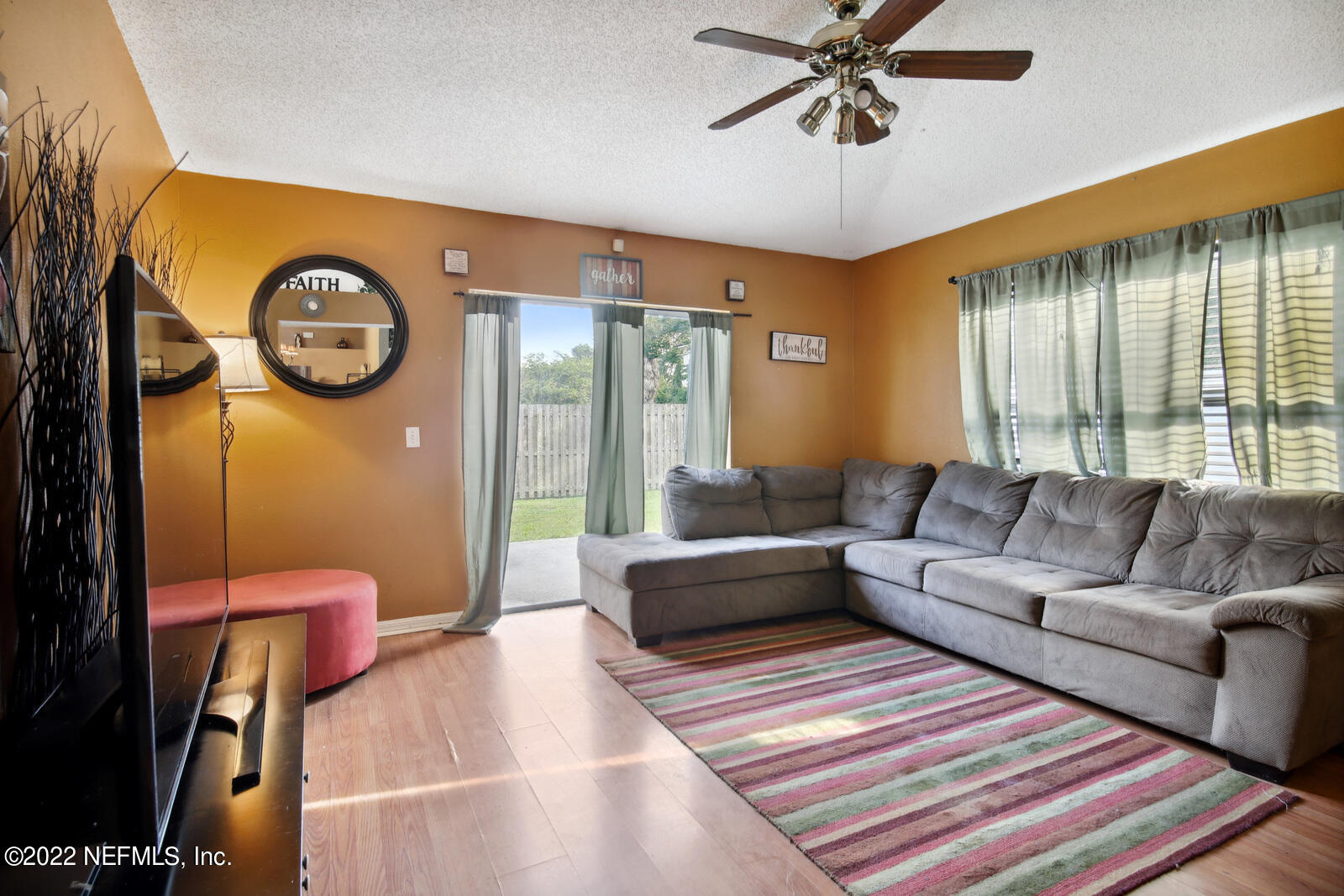 7354 High Bluff Road North Jacksonville, FL 32244 - Photo 8 of 26 a living room with furniture a chandelier fan and a rug