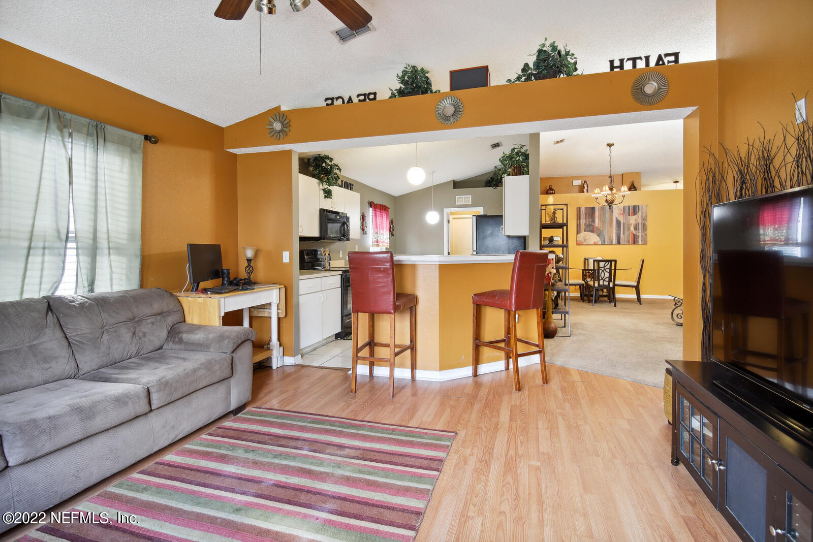 7354 High Bluff Road North Jacksonville, FL 32244 - Photo 9 of 26 a living room with furniture and a flat screen tv