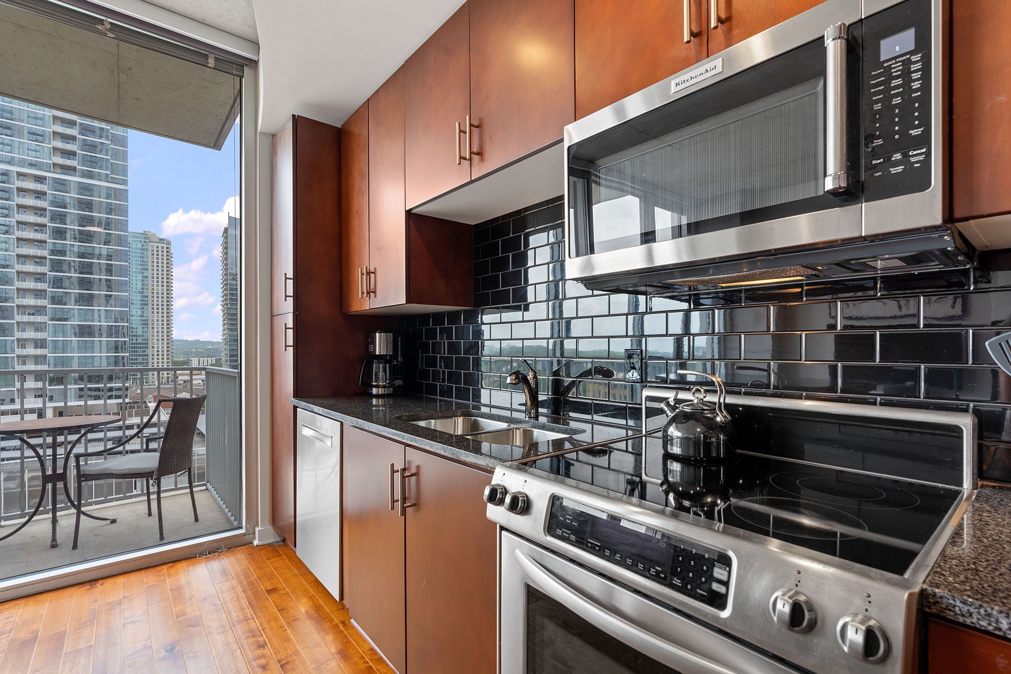 360 Nueces Street, Unit 1310 Austin, TX 78701 - Photo 12 of 40 a kitchen with a stove and a microwave